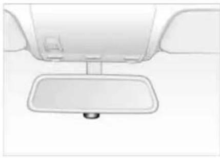 Top-down view of a car interior showing the front wheel, rear seats, and a rectangular reflector (no text or symbols)