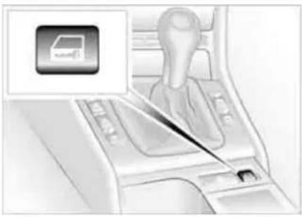 Interior view of a car infotainment system showing a hand tool interacting with the dashboard (no text or symbols visible)