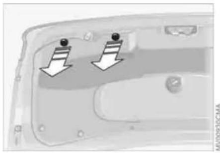 Close-up of a car door panel with two arrows pointing to the front panel (no text or symbols visible)