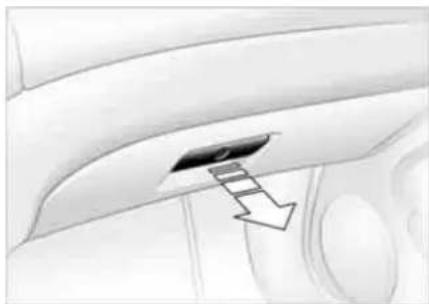 Interior view of a car showing the dashboard and seat area with an arrow pointing to a specific panel (no text or symbols present)