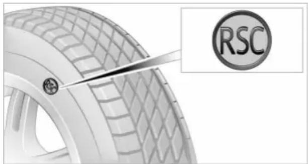 Close-up of a car tire with a visible RSC logo and a tool interacting with it (no text or symbols on the tire itself)