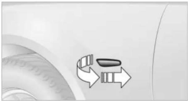 Close-up of a car tire with two directional arrows pointing to the wheel rim (no text or symbols)