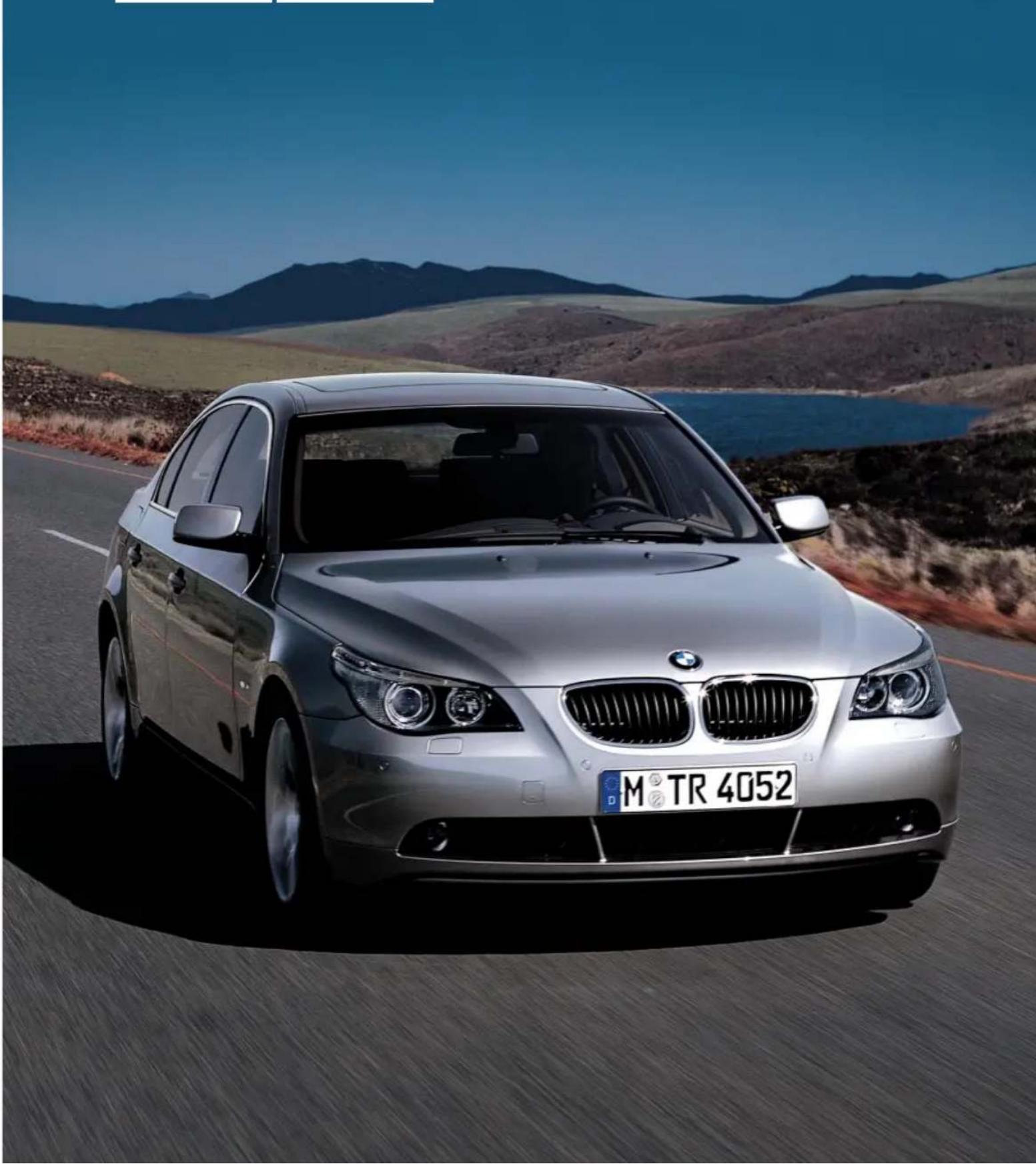 Silver BMW sedan driving on a road with mountainous background (no visible text or symbols)