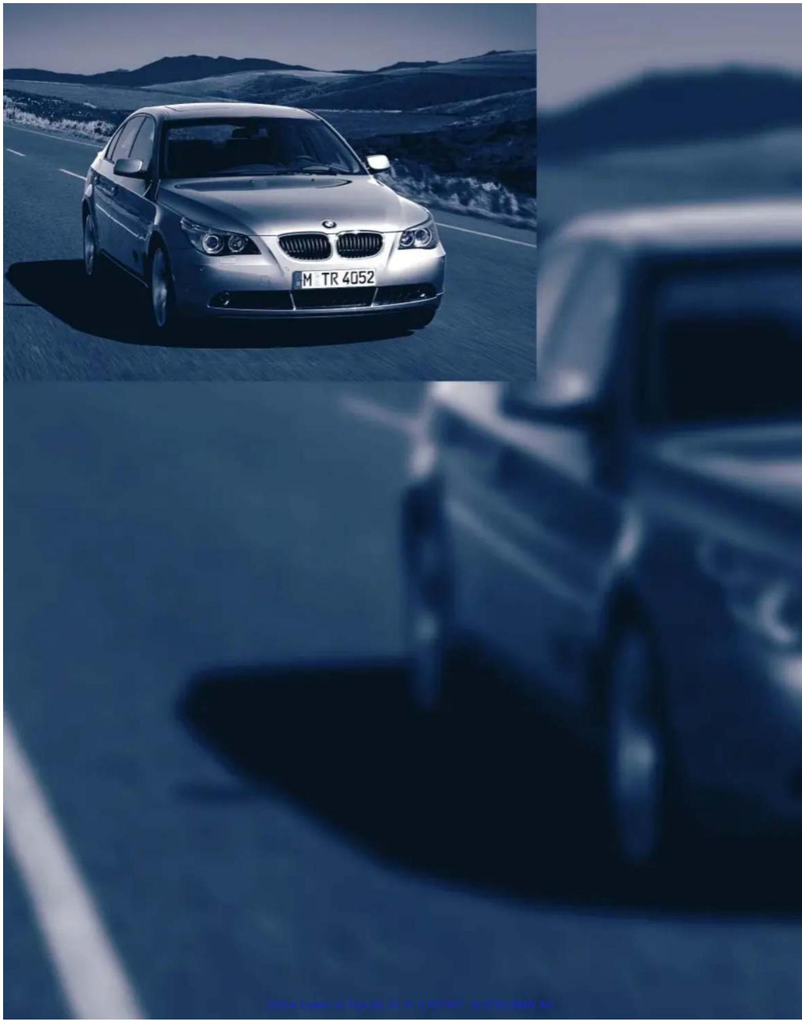 Exterior view of a silver BMW sedan on a highway with mountainous background (no signage)