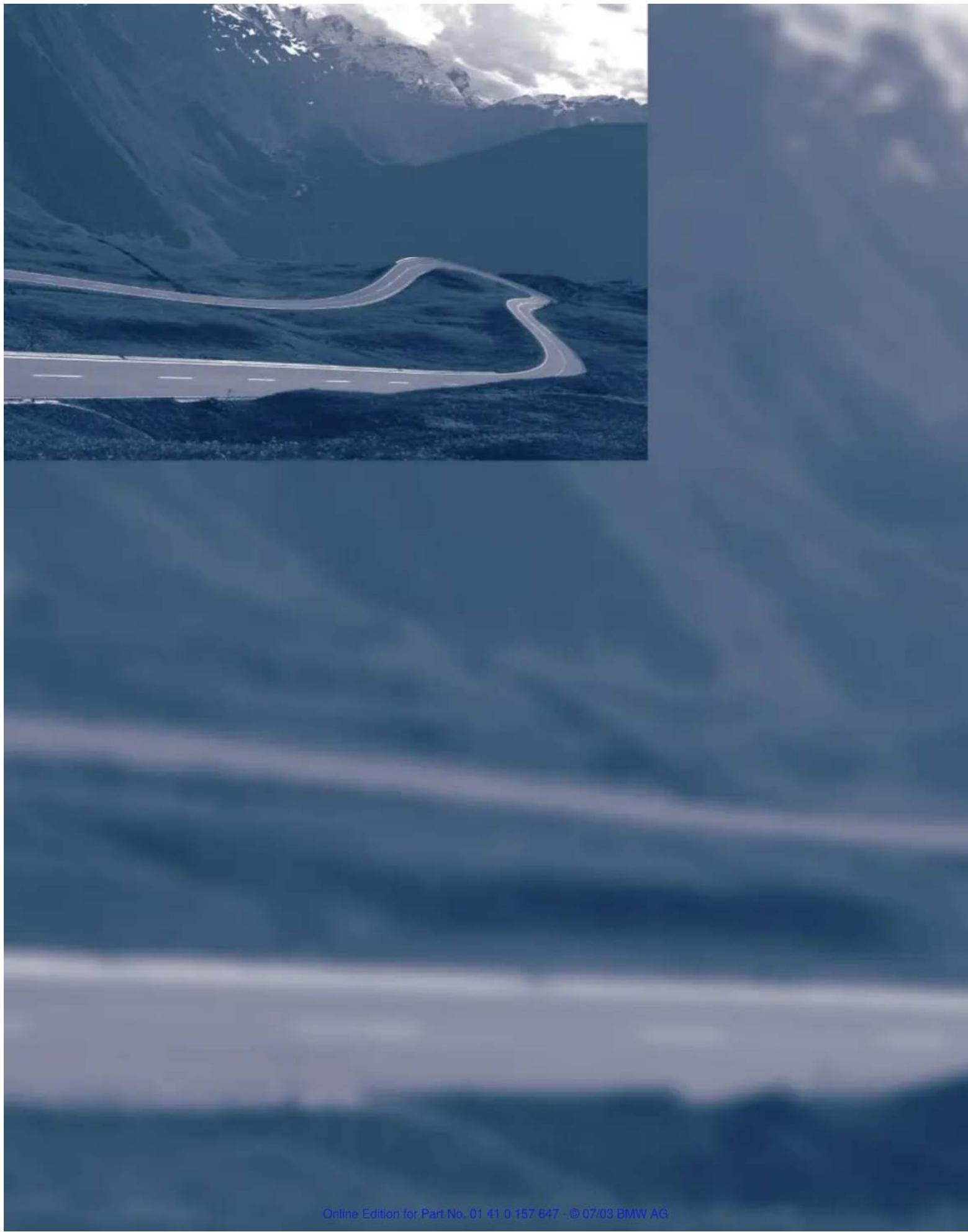 Aerial view of a winding mountain road through deep blue sky with snow-capped peaks in the background (no visible text or symbols)