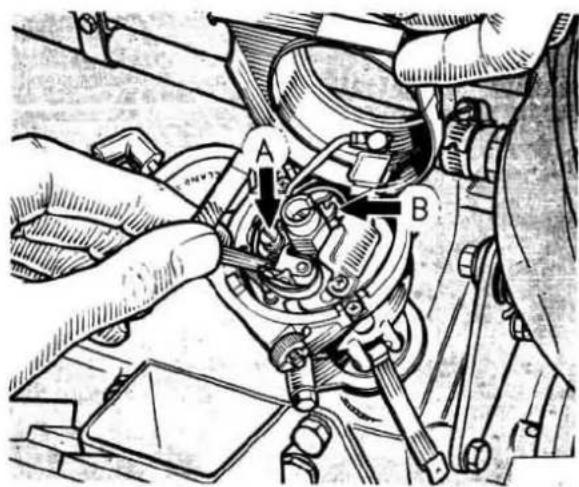 Technical diagram of a mechanical assembly with labeled parts A and B, showing hands operating components.