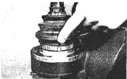 Close-up of a hand pressing down on a mechanical component (no visible text or symbols)
