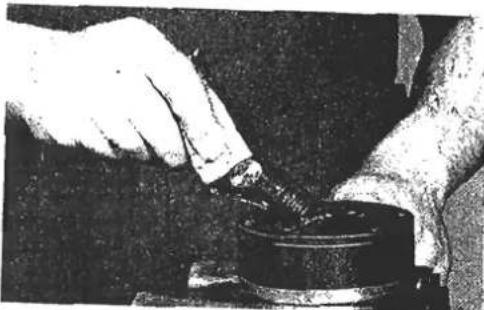 Close-up of hands pouring liquid into a container (no visible text or symbols)