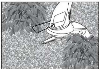 Illustration of a manual lawn saw cutting through dense grass (no text or symbols)