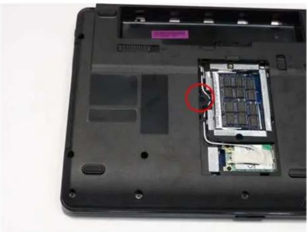 Laptop back with visible internal circuit board and a red circle highlighting a component (no text or symbols)