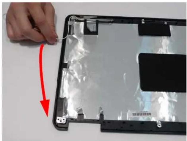 Close-up of a hand holding a plastic-wrapped device with a red arrow pointing to it, no visible text or symbols.