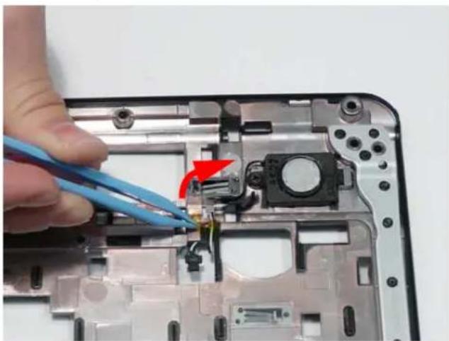 Close-up of a hand using blue wires to adjust cable to a component on a plastic electronic device (no text or symbols visible).