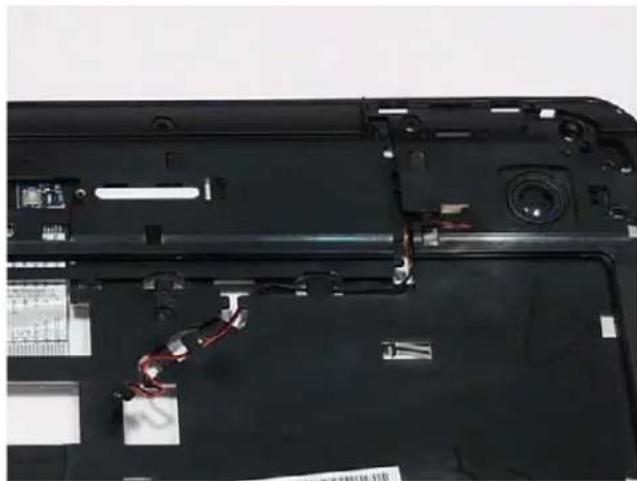 Close-up of a laptop's front panel showing internal components and wiring. No visible text or symbols.