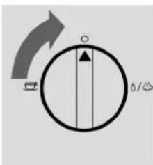 Diagram showing a circular dial with directional arrows and a central vertical line, likely indicating rotation or movement in a mechanical or electrical component.