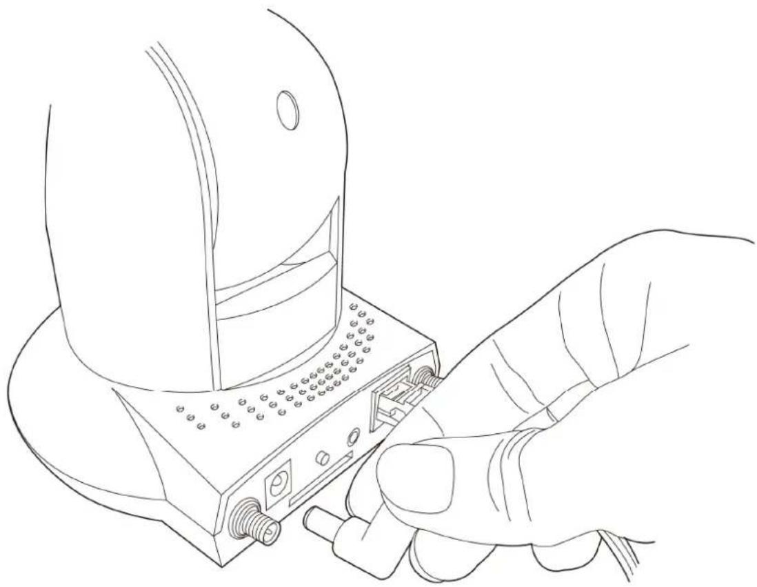 Line drawing of a hand inserting a device into a socket (no text or symbols)