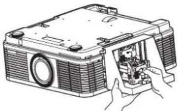 Line drawing of a projector with open lid and internal components, hands adjusting part (no text or symbols)