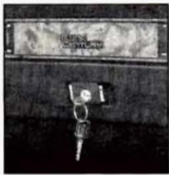 Black-and-white photo of a person holding a sign with Chinese characters above it, possibly a sign or label.