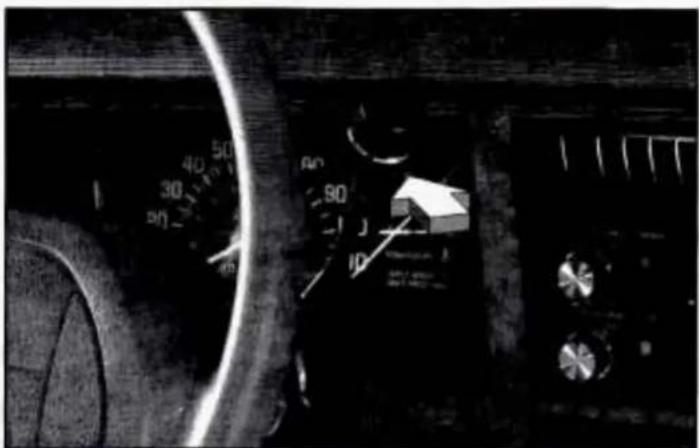 Close-up of a car dashboard with visible speedometer and control knob, showing numerical readings and a small box labeled '10'.