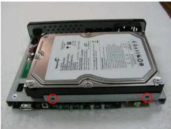 Internal view of a hard disk drive with visible printed labels and mounting points marked in red.
