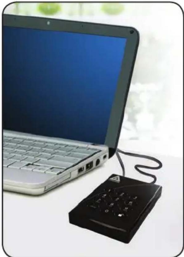 Laptop with keyboard and a black handheld device connected by a cable, placed on a white surface (no text or symbols visible)