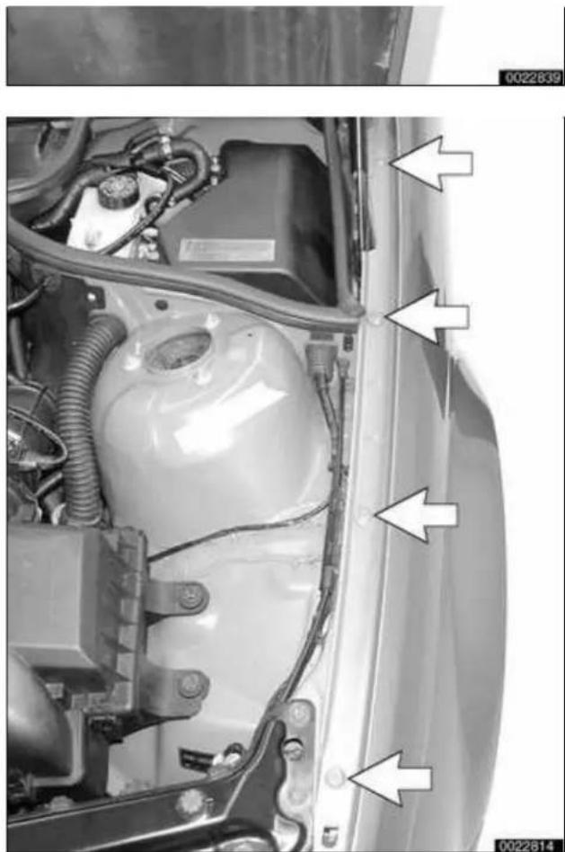 Close-up of a car's front engine compartment showing internal components and wiring (no text or symbols visible)