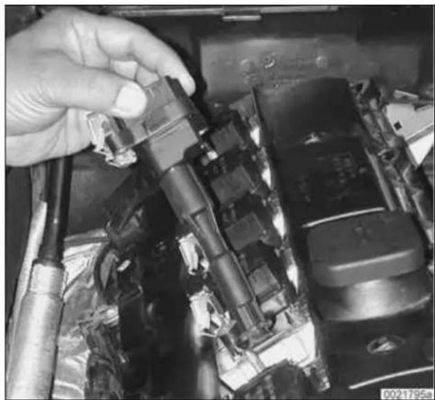 Close-up of a hand adjusting a mechanical component with visible wiring and components (no text or symbols).