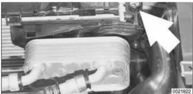 Close-up of a mechanical component with pipes and a coiled spring-like structure, no visible text or symbols
