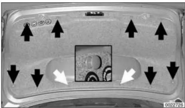 Close-up of a transparent container with black arrows pointing upward and downward, featuring a central square containing circular patterns (no text or symbols visible)