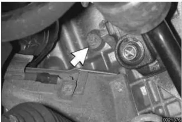 Close-up of a mechanical component with a white arrow pointing to a specific feature (no visible text or symbols)