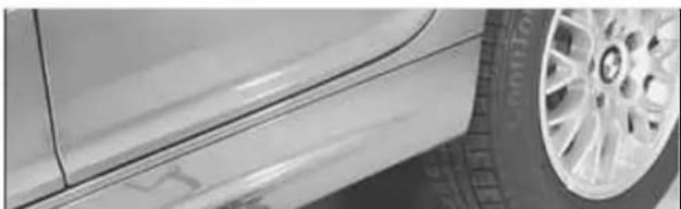 Close-up of a car's side profile with visible tire and wheel (no text or symbols).