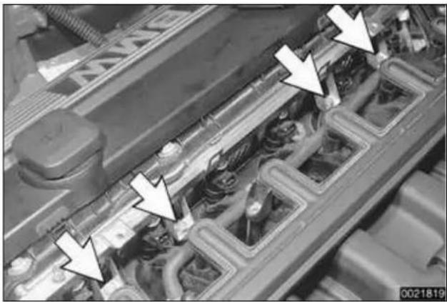 Close-up of an engine cylinder head with visible cooling pipes and mounting flanges (no text or symbols)