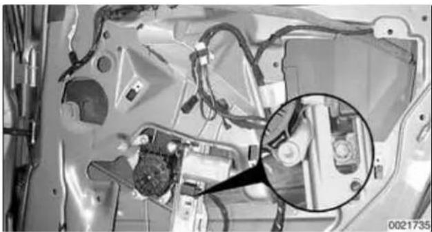 Close-up of a car interior showing mechanical components and wiring, with a magnified inset highlighting a specific component (no text or symbols visible).