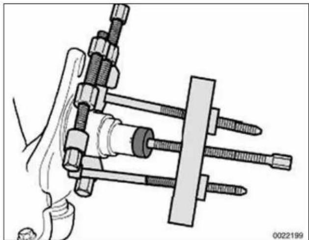 Mechanical assembly diagram showing a hand holding a tool with multiple bolts and a central bracket (no text or symbols visible)
