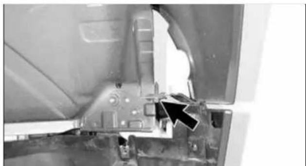 Close-up of a mechanical component with a black arrow pointing to a feature, no visible text or symbols