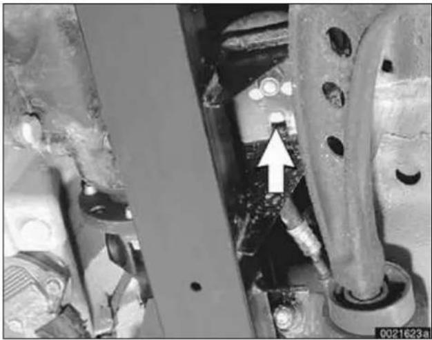 Close-up of mechanical components with a white arrow pointing to a specific part (no visible text or symbols).