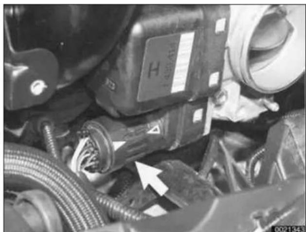 Close-up of mechanical components with hoses and a labeled component (no readable text or symbols)