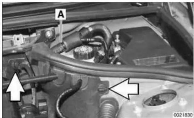 Close-up of an automotive engine bay with visible hoses and components, no readable text or symbols present