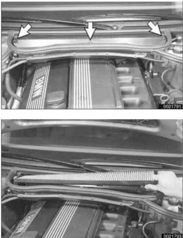 Close-up of a car engine bay with visible structural elements and mounting brackets.