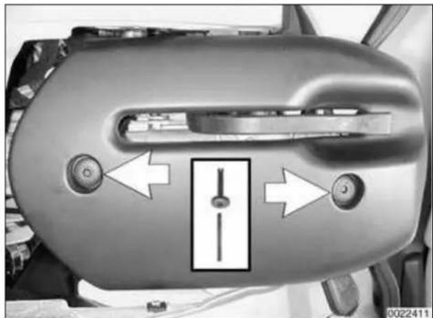 Close-up of a car's front panel showing handle, buttons, and a central vertical component (no text or symbols visible)