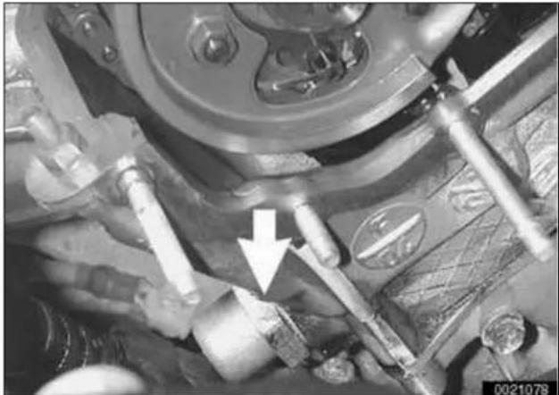 Close-up mechanical assembly with gears and tools, no visible text or symbols
