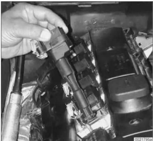 Close-up of a hand adjusting a component with visible wiring and mechanical parts (no text or symbols).