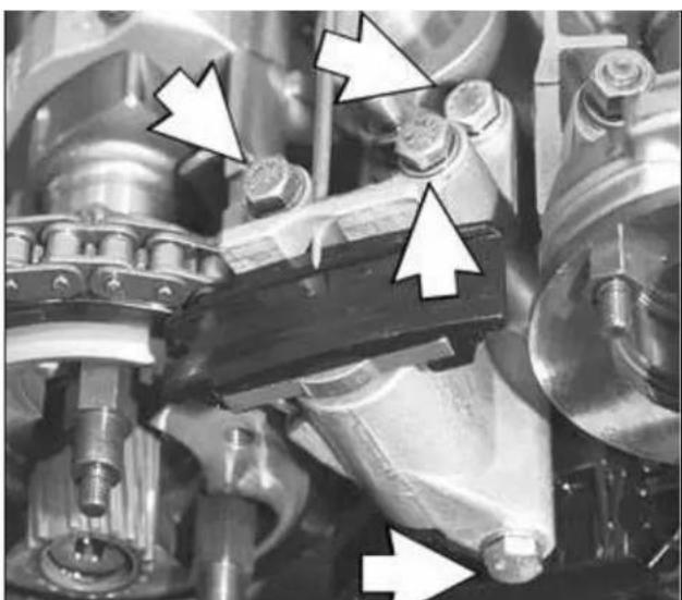 Close-up of mechanical components with white arrows pointing to specific parts (no visible text or symbols).