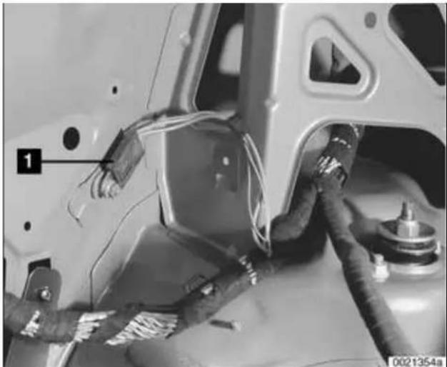 Close-up of a car's front panel with visible wiring and components, no text or symbols present