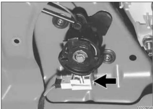 Close-up of a mechanical component with a black arrow pointing to a small component (no visible text or symbols).