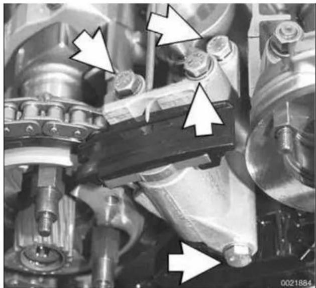 Close-up of mechanical components with white arrows pointing to specific parts (no visible text or symbols)