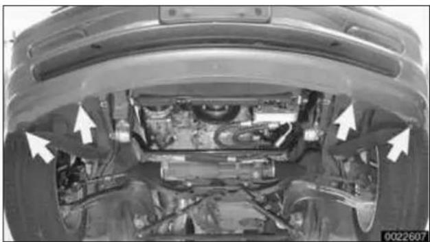 Top-down view of a car's undercarriage showing engine, wheel, and suspension components, with no visible text or symbols.