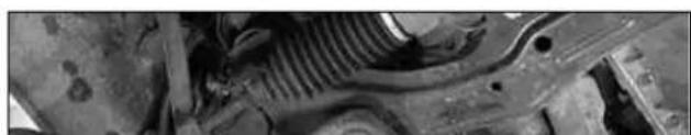 Close-up of a mechanical component with visible internal structure and mounting holes (no text or symbols)