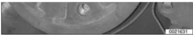 Close-up of a mechanical component with a central hole and textured surface (no visible text or symbols)