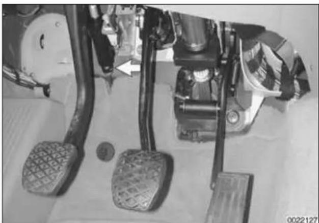Close-up of a car's brake system with two purple brake pads and a yellow valve, no visible text or symbols