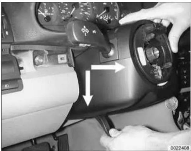 Close-up of hands operating a car dashboard with steering wheel and directional arrows.